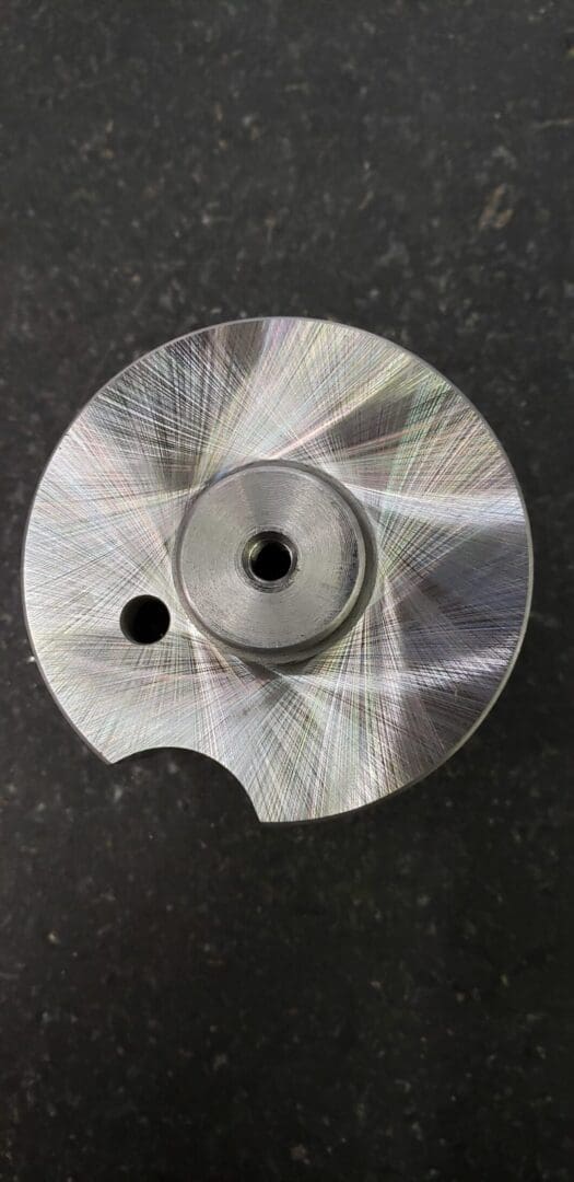 A metal disc with a hole in it.